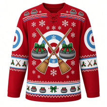 Load image into Gallery viewer, Ugly Christmas Curling Stone Cheer Hockey Jersey in Cranberry Red, front view – cranberry red body and crossed curling brooms over target rings flanked by two granite curling stones with a curling-stone and bow yoke, target-ring shoulder patches and bow and holly sleeve bands – custom name and number