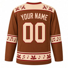 Load image into Gallery viewer, Ugly Christmas Folk Fiddle Hoedown Hockey Jersey in Fiddle Brown, back view with a cream yoke with red holly and notes, cream YOUR NAME and 00 trimmed in red on brown, music-staff bands and a holly hem band – your name and number
