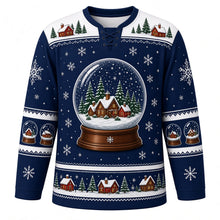 Load image into Gallery viewer, Ugly Christmas Snow Globe Village Hockey Jersey in Midnight Blue, front view – midnight blue body with icy white yoke with a giant snow globe crest with tiny glowing cottages, snowy pines and swirling snow, snow globe yoke, cottage and pine sleeve bands and a globe-and-house hem band – custom name and number