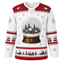 Load image into Gallery viewer, Ugly Christmas Snow Globe Village Hockey Jersey in Frost White, front view – frost white body with red yoke with a giant snow globe crest with tiny glowing cottages, snowy pines and swirling snow, snow globe yoke, cottage and pine sleeve bands and a globe-and-house hem band – custom name and number