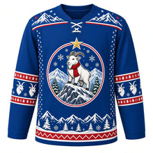 Load image into Gallery viewer, Ugly Christmas Mountain Goat Summit Hockey Jersey in Alpine Blue, front view – round medallion crest of a white mountain goat in a red scarf on a snowy rocky peak with pines and a gold star, snowy-peak yoke and goat-head sleeve bands – custom name and number
