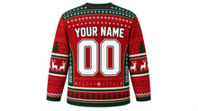 Load image into Gallery viewer, Ugly Christmas Reindeer Riot Hockey Jersey in Red, back view – red body with evergreen yoke and side panels – a fair-isle yoke, patterned side panels and sleeve bands, a pine-tree hem stripe band, arched YOUR NAME lettering and a big 00 number – custom name and number