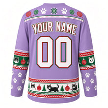 Load image into Gallery viewer, Ugly Christmas Kitty Ornament Chaos Hockey Jersey in Lavender Purple, back view with a paw-print, yarn-ball and snowflake yoke, cat-face and bauble sleeve bands, paw-print sleeves, a cats-trees-and-ornaments hem band, arched YOUR NAME lettering and 00 – custom name and number
