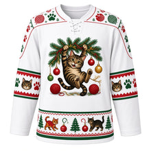 Load image into Gallery viewer, Ugly Christmas Kitty Ornament Chaos Hockey Jersey in Snow White, front view – snow white body with a tabby cat dangling from a pine branch batting baubles above tangled tinsel and yarn balls, paw-print yoke, cat-face sleeve bands and a cats-and-pines hem band – custom name and number