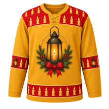 Load image into Gallery viewer, Ugly Christmas Candlelit Lanterns Hockey Jersey in Lantern Gold, front view – lantern gold body, glowing black lantern with a lit candle, pine boughs, holly berries and a red bow on the chest, holly red candle yoke, lantern and candle sleeve bands and a hem row of lit candles – custom name and number