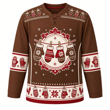 Load image into Gallery viewer, Ugly Christmas Mitten Clothesline Hockey Jersey in Cocoa Brown, front view – round cream crest of four red, cream and brown knit mittens hung on a clothesline with clothespins in a red poinsettia and holly wreath, mitten yoke, cream mitten sleeve bands and a cream and red hem band – custom name and number