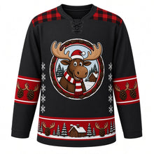 Load image into Gallery viewer, Ugly Christmas Moose Lodge Hockey Jersey in Charcoal Black, front view – charcoal black body with red plaid yoke with a round cartoon moose crest with a striped scarf by a snowy log cabin, plaid yoke, antler and pinecone sleeve bands and a pinecone hem band – custom name and number
