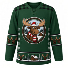 Load image into Gallery viewer, Ugly Christmas Moose Lodge Hockey Jersey in Pine Green, front view – pine green body with green-and-black plaid yoke with a round cartoon moose crest with a striped scarf by a snowy log cabin, plaid yoke, antler and pinecone sleeve bands and a pinecone hem band – custom name and number