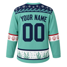 Load image into Gallery viewer, Ugly Christmas Sea Otter Snowfall Hockey Jersey in Seafoam Mint, back view with deep navy wave and snowflake yoke, red scallop shell sleeve bands and a kelp and bubble hem band, arched YOUR NAME and 00 – your name and number