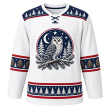 Load image into Gallery viewer, Ugly Christmas Snowy Owl Woods Hockey Jersey in Frost White, front view – frost white body with navy yoke with a round owl crest on a snowy pine branch under a crescent moon, pine-tree-and-star yoke, pinecone sleeve bands and a pine-tree hem band – custom name and number