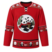 Load image into Gallery viewer, Ugly Christmas Panda Snow Romp Hockey Jersey in Berry Red, front view – two pandas snuggling in fresh snow with a red scarf and gift under bamboo and a decorated tree, white panda-face yoke with green zigzag, panda-and-present sleeve bands and a snowball and bamboo hem band – custom name and number