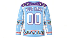 Load image into Gallery viewer, Ugly Christmas Penguin Party Hockey Jersey in Glacier Blue, back view with a penguin and snowflake yoke, penguin sleeve bands, penguin-parade hem band, YOUR NAME lettering and 00 – custom name and number
