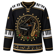 Load image into Gallery viewer, Ugly Christmas Piano Lounge Noel Hockey Jersey in Midnight Black, front view – round crest of a black grand piano and a gold saxophone with gold music notes and holly, ringed by glowing string lights, piano-key yoke, piano-key elbow bands with gold stars on the sleeves and a gold music-note hem band – custom name and number