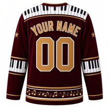 Load image into Gallery viewer, Ugly Christmas Piano Lounge Noel Hockey Jersey in Velvet Burgundy, back view with a piano-key yoke on velvet burgundy, piano-key elbow bands, a music-note hem band and gold YOUR NAME and 00 – your name and number