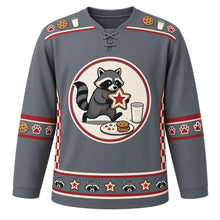 Load image into Gallery viewer, Ugly Christmas Raccoon Cookie Heist Hockey Jersey in Slate Gray, front view – round cream crest of a masked raccoon tiptoeing away with a star-shaped frosted cookie beside a glass of milk and a cookie plate, cookie and milk-glass yoke, red-striped cookie and paw print elbow bands, red checkerboard side panels and a raccoon-face and star cookie hem band – custom name and number