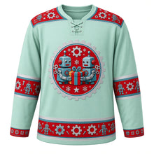 Load image into Gallery viewer, Ugly Christmas Tin Toy Robots Hockey Jersey in Mint Green, front view – mint green body with red robot-and-gear yoke with a round gear-ring crest of two retro wind-up tin robots holding a wrapped gift with snowflakes and a star, plus robot, gear, bolt and star bands – custom name and number