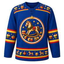 Load image into Gallery viewer, Ugly Christmas Rocking Horse Toybox Hockey Jersey in Royal Blue, front view – royal blue body and a painted wooden rocking horse in a holly garland with toy drums, plain wooden blocks and gold stars with a toy drum and star yoke and spinning-top sleeve bands – custom name and number