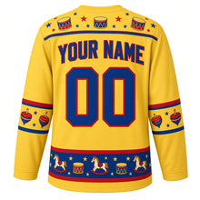 Load image into Gallery viewer, Ugly Christmas Rocking Horse Toybox Hockey Jersey in Butter Yellow, back view with a toy drum and star yoke, a hem band of little rocking horses, drums and blocks, arched YOUR NAME lettering and 00 – custom name and number