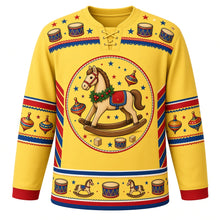 Load image into Gallery viewer, Ugly Christmas Rocking Horse Toybox Hockey Jersey in Butter Yellow, front view – butter yellow body and a painted wooden rocking horse in a holly garland with toy drums, plain wooden blocks and gold stars with a toy drum and star yoke and spinning-top sleeve bands – custom name and number