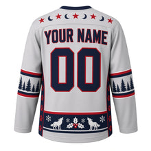 Load image into Gallery viewer, Ugly Christmas Moonlit Wolf Pack Hockey Jersey in Silver Frost, back view with a star-and-crescent-moon yoke, pine tree and paw print sleeve bands, a howling wolf, holly and snowflake hem band, YOUR NAME lettering and 00 – custom name and number