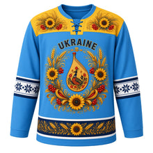 Load image into Gallery viewer, Ukraine Original Hockey Jersey in Carpathian Blue, front view – ornate vinok wreath crest of sunflowers, wheat and kalyna around a bandura, Petrykivka yoke, detailed artwork, custom name and number