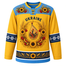 Load image into Gallery viewer, Ukraine Original Hockey Jersey in Wheat Field Yellow, front view – ornate vinok wreath crest of sunflowers, wheat and kalyna around a bandura, Petrykivka yoke, detailed artwork, custom name and number
