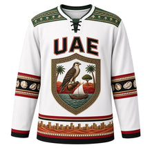 Load image into Gallery viewer, United Arab Emirates Original Hockey Jersey in Pearl White, front view – ornate Al Sadu shield crest with falcon, dhow and ghaf tree, detailed artwork, custom name and number