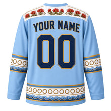Load image into Gallery viewer, Uruguay Original Hockey Jersey in Celeste Sky, back view with your name and number – gaucho-braid and ceibo yoke with candombe drum sleeve bands
