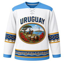Load image into Gallery viewer, Uruguay Original Hockey Jersey in Rambla White, front view – ornate oval cameo crest with gaucho, ombú tree, candombe drums and ceibo flowers, detailed artwork, custom name and number
