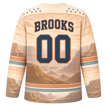 Load image into Gallery viewer, USA Patriotic Canyon Sunset Flag Hockey Jersey in Mesa Sandstone, back view with your name and number – light sand mesas with terracotta and turquoise bands