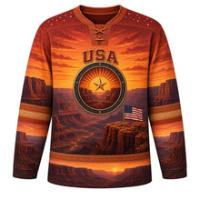 Load image into Gallery viewer, USA Patriotic Canyon Sunset Flag Hockey Jersey in Red Rock Sienna, front view – rust-red canyon walls under a fiery sunset with a small flag patch by the sun-and-star crest, custom name and number