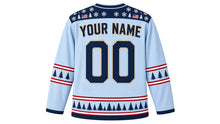 Load image into Gallery viewer, USA Patriotic Frozen Pond Sunrise Hockey Jersey in Pond Ice, back view with your name and number – snowflake, pine and small flag patterned yoke with candy-stripe sleeve bands