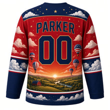 Load image into Gallery viewer, USA Patriotic Liberty Balloon Skies Hockey Jersey in Sunrise Red, back view with your name and number – a band of puffy white clouds and tiny gold stars yoke with matching sleeve and hem bands
