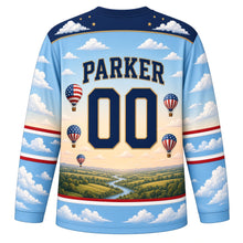Load image into Gallery viewer, USA Patriotic Liberty Balloon Skies Hockey Jersey in Morning Sky Blue, back view with your name and number – a band of puffy white clouds and tiny gold stars yoke with matching sleeve and hem bands