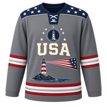 Load image into Gallery viewer, USA Patriotic Lighthouse Coast Beacon Hockey Jersey in Granite Shore Gray, front view – striped lighthouse on a rocky shoreline with a flag-stripe beam, custom name and number