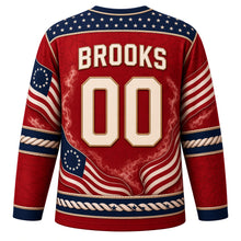 Load image into Gallery viewer, USA Patriotic Revolutionary Drum Corps Hockey Jersey in Musket Red, back view with your name and number – a decorative yoke of tiny parchment-colored stars on navy with a fine rope-cord border yoke, matching sleeve and hem bands
