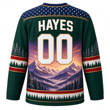 Load image into Gallery viewer, USA Patriotic Rocky Mountain Majesty Hockey Jersey in Pine Ridge Green, back view with your name and number – a decorative yoke of tiny white stars on navy edged with a thin gold mountain-ridge zigzag line yoke, matching sleeve and hem bands