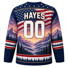 Load image into Gallery viewer, USA Patriotic Rocky Mountain Majesty Hockey Jersey in Summit Navy, back view with your name and number – a decorative yoke of tiny white stars on navy edged with a thin gold mountain-ridge zigzag line yoke, matching sleeve and hem bands
