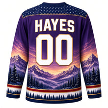 Load image into Gallery viewer, USA Patriotic Rocky Mountain Majesty Hockey Jersey in Alpenglow Purple, back view with your name and number in bold white and gold – alpenglow peaks and pine forest under a star yoke