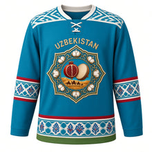 Load image into Gallery viewer, Uzbekistan Original Hockey Jersey in Samarkand Blue, front view – ornate suzani rosette crest with pomegranate, cotton and doira drum, ikat yoke, detailed artwork, custom name and number
