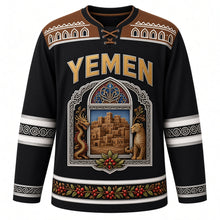 Load image into Gallery viewer, Yemen Original Hockey Jersey in Basalt Black, front view – ornate qamariya window crest with Shibam tower houses and dragon's blood tree, gypsum-frieze yoke, detailed artwork, custom name and number