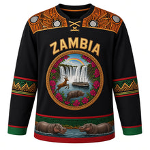 Load image into Gallery viewer, Zambia Original Hockey Jersey in Kafue Black, front view – ornate woven-basket roundel with Victoria Falls, Kuomboka barge and Kafue lechwe, chitenge yoke, detailed artwork, custom name and number