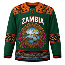 Load image into Gallery viewer, Zambia Original Hockey Jersey in Zambezi Green, front view – ornate woven-basket roundel with Victoria Falls, Kuomboka barge and Kafue lechwe, chitenge yoke, detailed artwork, custom name and number