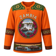 Load image into Gallery viewer, Zambia Original Hockey Jersey in Copperbelt Orange, front view – ornate woven-basket roundel with Victoria Falls, Kuomboka barge and Kafue lechwe, chitenge yoke, detailed artwork, custom name and number