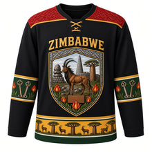 Load image into Gallery viewer, Zimbabwe Original Hockey Jersey in Granite Black, front view – ornate stone-block shield crest with sable antelope, Great Zimbabwe walls and flame lilies, chevron masonry yoke, detailed artwork, custom name and number