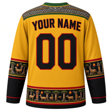 Load image into Gallery viewer, Zimbabwe Original Hockey Jersey in Kopje Gold, back view with your name and number – dry-stone chevron masonry yoke and mbira-key sleeve bands